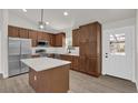 Modern kitchen with stainless steel appliances, island, and ample cabinet space at 4356 Sw Dahlia Ct, Dunnellon, FL 34431