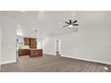 Bright and airy open-concept living space with wood floors and ceiling fan at 4356 Sw Dahlia Ct, Dunnellon, FL 34431