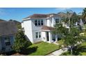 Two-story house nestled in a neighborhood, showcasing landscaping at 4636 Southlawn Ave, Orlando, FL 32811