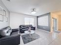 Stylish living room featuring modern decor, comfortable seating, and tile flooring at 651 Tortugas St, Haines City, FL 33844