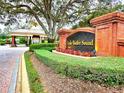 Elegant community entrance featuring brick pillars, lush landscaping, and prominent signage for Lake Butler Sound at 6533 Cartmel Ln, Windermere, FL 34786