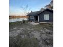 Dark gray house with waterfront view at 310 Lake Ave, Dundee, FL 33838