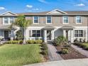 Attractive townhome featuring well-maintained landscaping and a welcoming brick walkway at 12043 Holystone St, Winter Garden, FL 34787