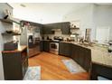 Modern kitchen with dark green cabinets, granite countertops, and stainless steel appliances at 12826 Forestedge Cir, Orlando, FL 32828