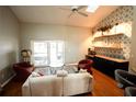 Spacious living area with hardwood floors, stylish seating, and access to a patio at 12826 Forestedge Cir, Orlando, FL 32828