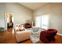 Bright living room featuring hardwood floors, comfy sofas, and a view to the backyard at 12826 Forestedge Cir, Orlando, FL 32828