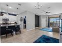 Spacious living room with tile floors, modern light fixtures and access to the Kitchen and Balcony at 17438 Promenade Dr, Clermont, FL 34711