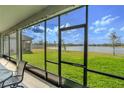 Screened porch overlooking a lake with patio furniture at 1756 Chatsworth Cir, St Cloud, FL 34771