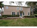 A charming townhouse with well-maintained lawn, colorful flower bed, and a covered entryway at 2011 Stockton Dr, Sanford, FL 32771