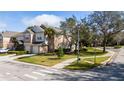 Corner lot townhome with attached garages, a sidewalk, and a street view at 2011 Stockton Dr, Sanford, FL 32771