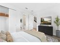 Bedroom with attached bath, large-screen TV, and closet for ample storage at 2221 Valentine Aly, Orlando, FL 32804