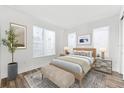 Bright bedroom with white walls, wood floors, a large window, and a comfortable bed at 2221 Valentine Aly, Orlando, FL 32804