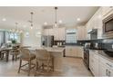 Modern kitchen with white cabinets, granite countertops, and stainless steel appliances at 2705 Serenity Meadow Dr, Kissimmee, FL 34744