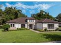 Beautiful home with a brown tile roof, stone accents, and a nicely landscaped yard at 32117 Red Tail Blvd, Sorrento, FL 32776
