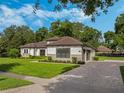 This home boasts a large, inviting front yard with a paved driveway at 32117 Red Tail Blvd, Sorrento, FL 32776