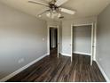 Cozy bedroom with wood floors, a ceiling fan, and a closet at 3213 Holderness Dr, Kissimmee, FL 34741