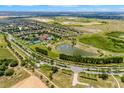 Expansive aerial view of the community highlighting the pond, community center, and lush green spaces at 3541 Belland Cir # A, Clermont, FL 34711