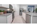 Modern kitchen with stainless steel appliances and granite countertops at 3547 Sandalwood Isle Way, Ocoee, FL 34761