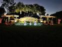 Festive community entrance sign with lighted snowmen and palm trees at dusk at 3610 Charmed Ln, St Cloud, FL 34772