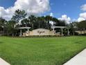An image of the Esprit community sign, set against a backdrop of lush green grass and palm trees on a sunny day at 3610 Charmed Ln, St Cloud, FL 34772