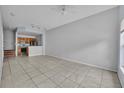 Bright, open-concept living area with tile floors adjacent to an open kitchen with modern, stainless appliances at 4004 Santa Maria Dr # 105, Kissimmee, FL 34741