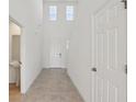 Bright hallway with tile flooring, high ceilings, and ample natural light coming from upper windows at 4026 Copperleaf Ln, Poinciana, FL 34759