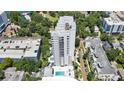 An aerial view shows a tall condominium complex with a swimming pool, parking, and views of the surrounding cityscape at 530 E Central Blvd # 102, Orlando, FL 32801