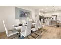 Bright dining room with a large white table and white chairs at 5414 Oakgrain Ct, Davenport, FL 33837