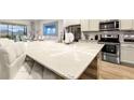 White quartz countertops and stainless steel appliances highlight this kitchen at 5414 Oakgrain Ct, Davenport, FL 33837