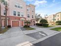 Three-story townhome with two-car garage, paved driveway, and street view at 8013 Cool Breeze Dr # 116, Orlando, FL 32819