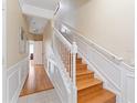 Elegant staircase with white railings and hardwood floors at 8013 Cool Breeze Dr # 116, Orlando, FL 32819