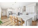 Bright, open kitchen features a large island, stainless appliances, and pendant lighting at 10231 Beechwood Ln, Orlando, FL 32832
