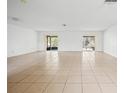 Spacious living room with tile flooring, white walls, and sliding glass doors that let in plenty of natural light at 10305 Licorice Way, Orlando, FL 32821