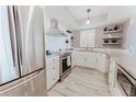 Bright kitchen with stainless steel appliances, white cabinetry, and modern fixtures at 111 S Atlantic Ave # 301, Ormond Beach, FL 32176