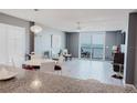 Living room with modern decor, water view and access to balcony at 111 S Atlantic Ave # 301, Ormond Beach, FL 32176