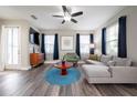 Bright living room featuring a ceiling fan, hardwood floors, and modern furniture at 1217 E Muriel St, Orlando, FL 32806