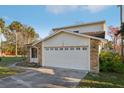 Home exterior with a two-car garage and decorative windows at 124 Loon Ct, Daytona Beach, FL 32119