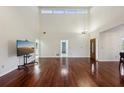 Open-concept living room with high ceilings and hardwood floors at 124 Loon Ct, Daytona Beach, FL 32119