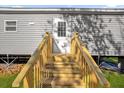 Wooden steps leading to the entrance of the manufactured home at 1356 Cupid Ave, Christmas, FL 32709