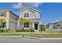 Charming two-story home featuring lush landscaping, an inviting front porch, and a freshly manicured lawn at 2429 Volunteer Ave, Kissimmee, FL 34744