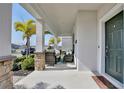 Covered porch with wicker seating and a view of the street at 2429 Volunteer Ave, Kissimmee, FL 34744