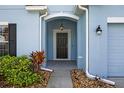 Inviting front porch with decorative plants and a stylish overhead light fixture at 3773 Moon Dancer Pl, St Cloud, FL 34772