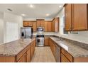Spacious kitchen with granite countertops, stainless steel appliances, and a center island at 3773 Moon Dancer Pl, St Cloud, FL 34772