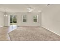 Bright and airy living room featuring large windows and sliding glass doors to the backyard at 3773 Moon Dancer Pl, St Cloud, FL 34772