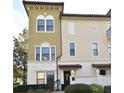 Front view of a tan townhome with a dark brown door and white trim at 4401 Messina Dr, Lake Mary, FL 32746