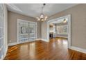 Open dining area with hardwood floors, chandelier, and French doors to the exterior at 817 Greenwood St, Orlando, FL 32801