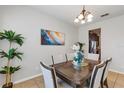 Elegant dining room with a stylish chandelier and seating for six, great for entertaining at 8375 Lovett Ave, Orlando, FL 32832