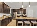 Modern kitchen featuring granite countertops, stainless steel appliances, and a functional island at 8375 Lovett Ave, Orlando, FL 32832