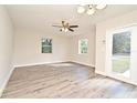 Bright living room featuring modern gray flooring and a ceiling fan at 878 Rockhill St, Deltona, FL 32725