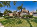 Inviting home exterior with a brick facade, large window, manicured shrubs, and a lush green lawn at 402 Turnstone Way, Orlando, FL 32828